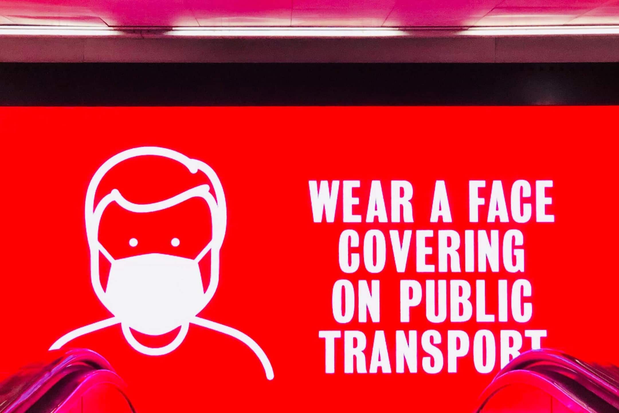 PSA billboard about wearing a face mask on public transport